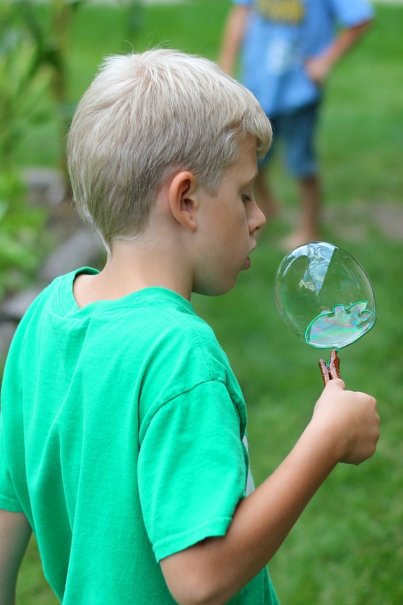 Catching a bubble on Apple Cinnamon Stick Bubble Wands - Inner Child Learning