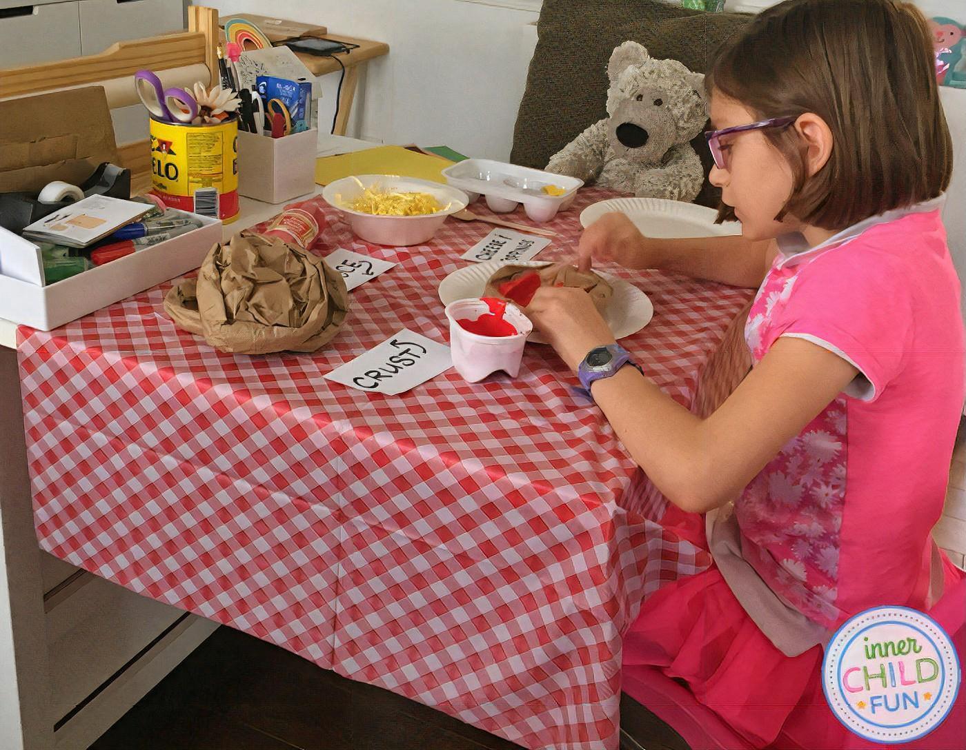 Pretend pizza restaurant with paper food.
